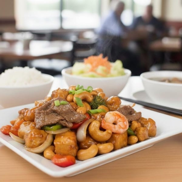 Stix By AZN's Asian stir-fry with beef, shrimp, tofu, cashews, and vegetables, served with rice and salad.